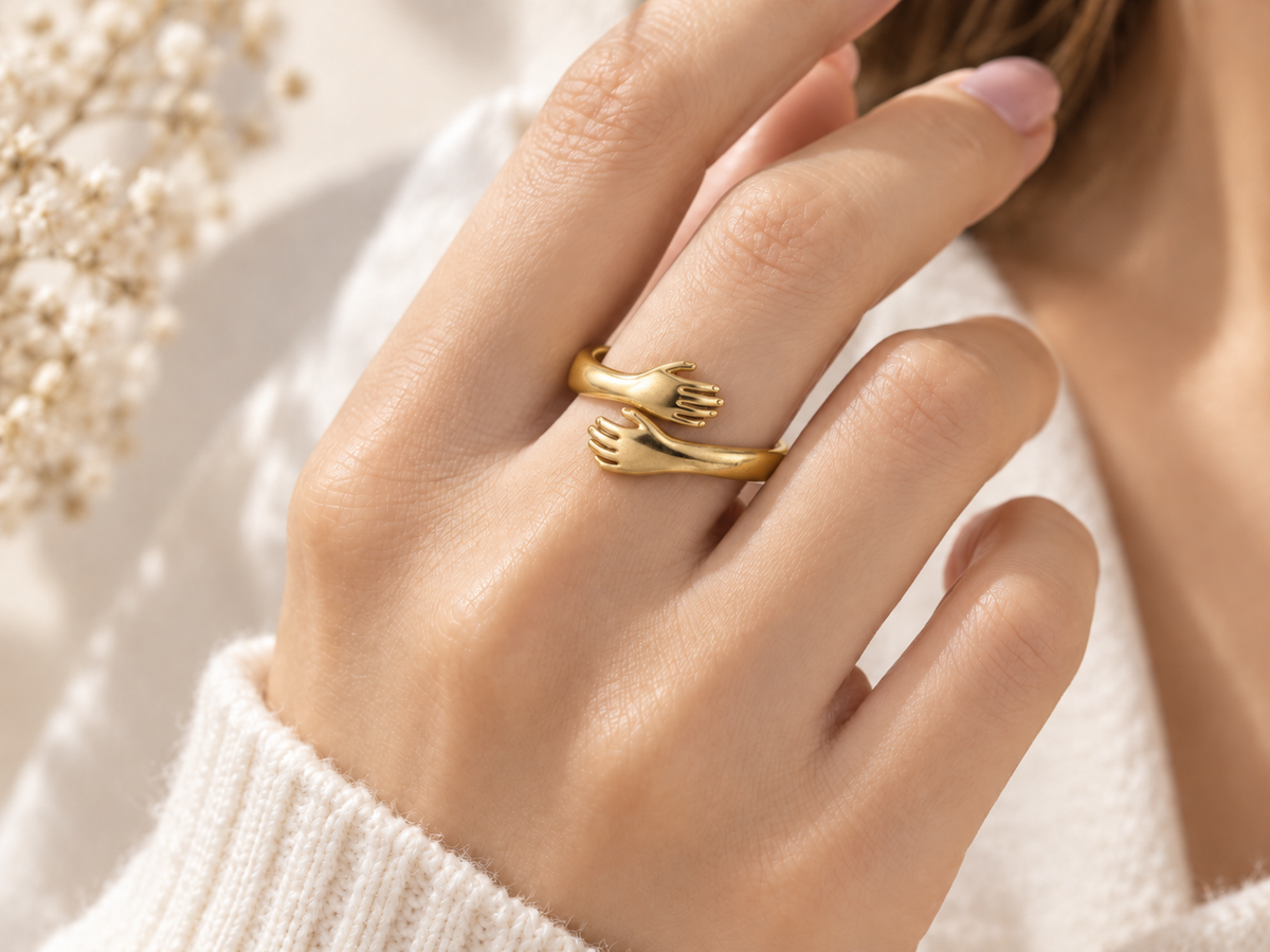 Gold Embrace Ring worn on a hand